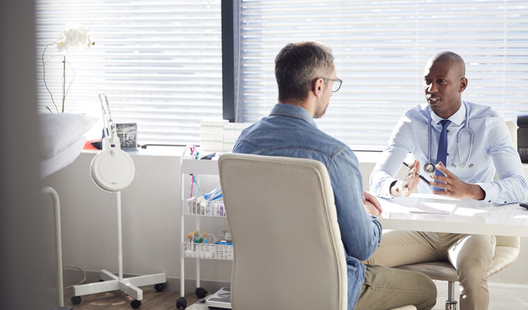 GP talking with male patient