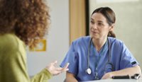 Female GP speaking to a patient. 