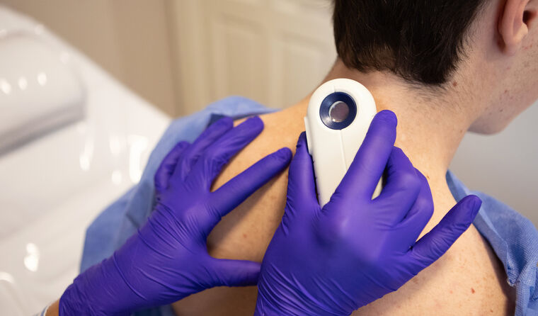 GP conducting skin check