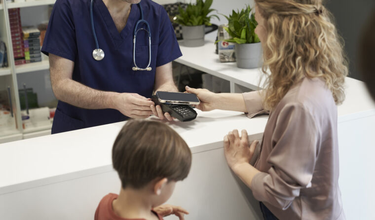 Person paying at the counter at doctors' office. 