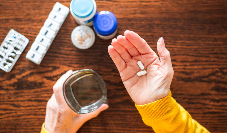 Hand reaching for various medications