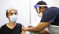 Teenager receiving a COVID-19 vaccine.
