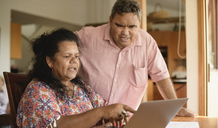 A couple using a laptop.