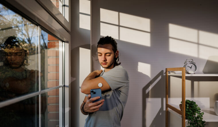 Man checking his diabetes patch.