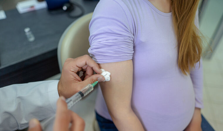 Pregnant woman having vaccine