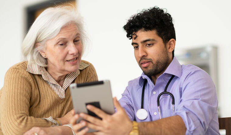 GP showing older patient the risk calculator.