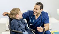 Doctor talks to boy with developmental disability.