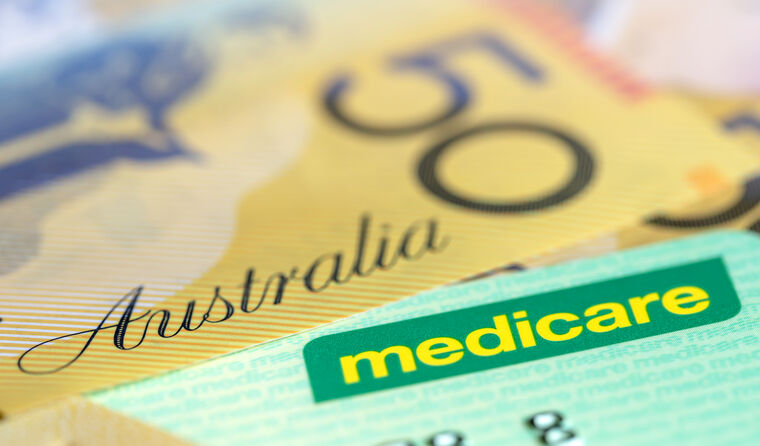 Australian $50 note sitting next to Medicare card,