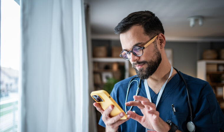 Doctor looking at his phone.