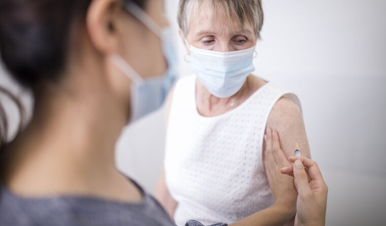 Doctor giving elderly patients a vaccine.