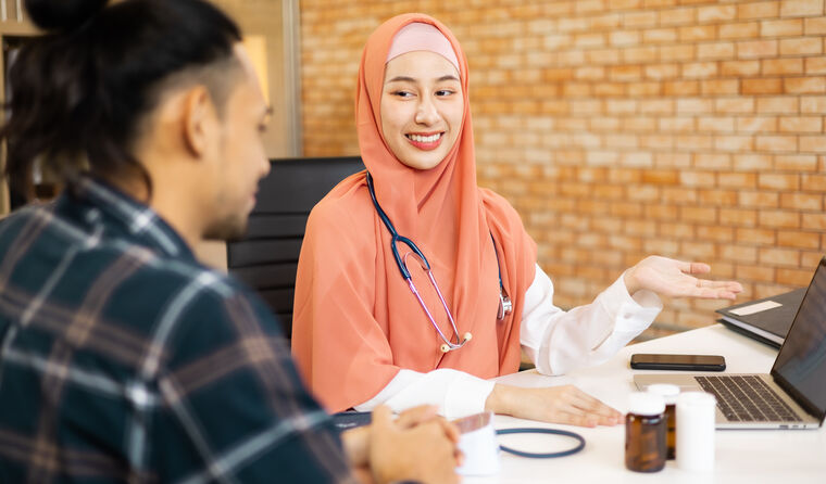 General practice registrar talking with patient