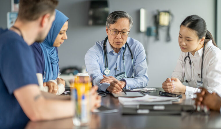 Doctors sitting around a table.