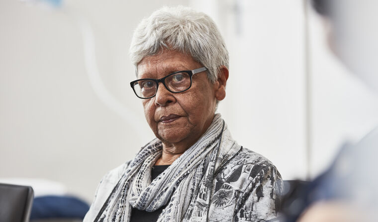 Aboriginal woman in GP consulting room.
