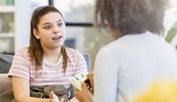 Young patient talks about vaccination with doctor
