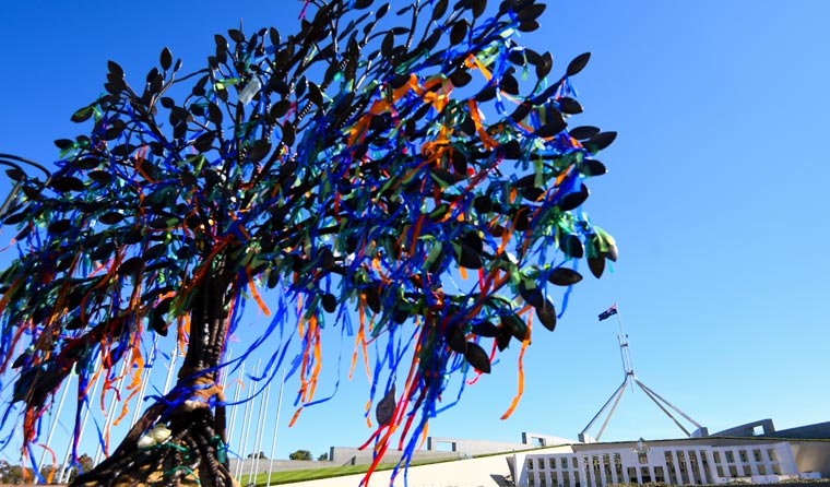 A tree sculpture was constructed outside of Parliament House as a memorial to victims and survivors of institutional child sexual abuse. (Image: Lukas Coch)
