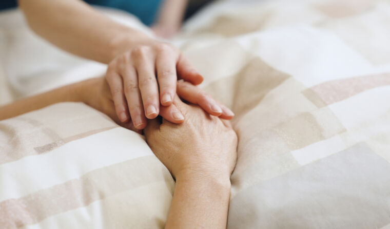 A person holding hands with a patient