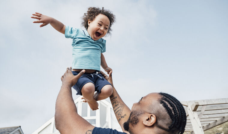 Father playing with his smiling young son