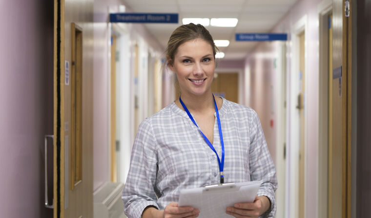 Young, female GP in hospital corridor