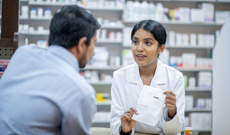 Pharmacist discussing script with patient