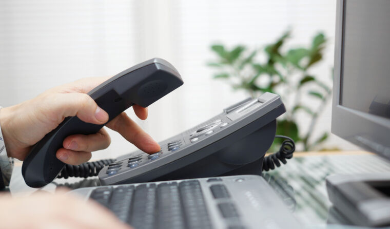 Hand dialing on a phone.