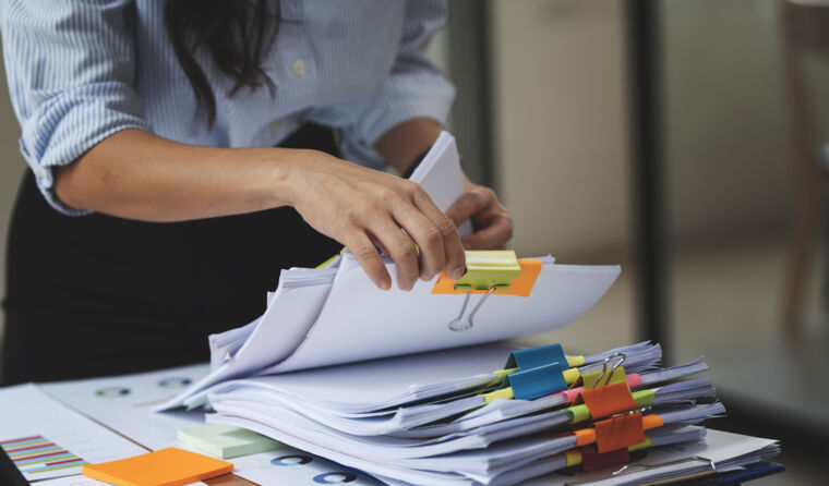 Person looking through paperwork.