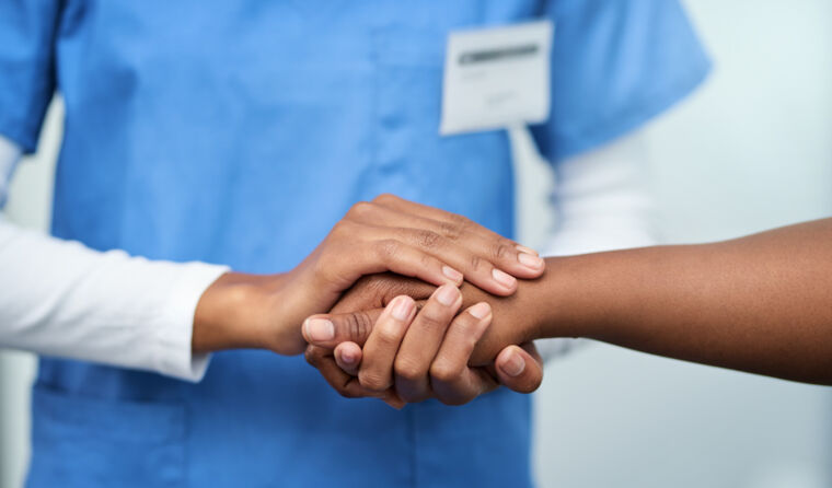 Doctor holding a patient's hand.