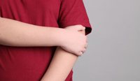 Child holding their arm.