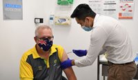 Dr Jesse Li giving Australian Prime Minister Scott Morrison his first dose of the Pfizer/BioNTech coronavirus vaccine. (Image: AAP)