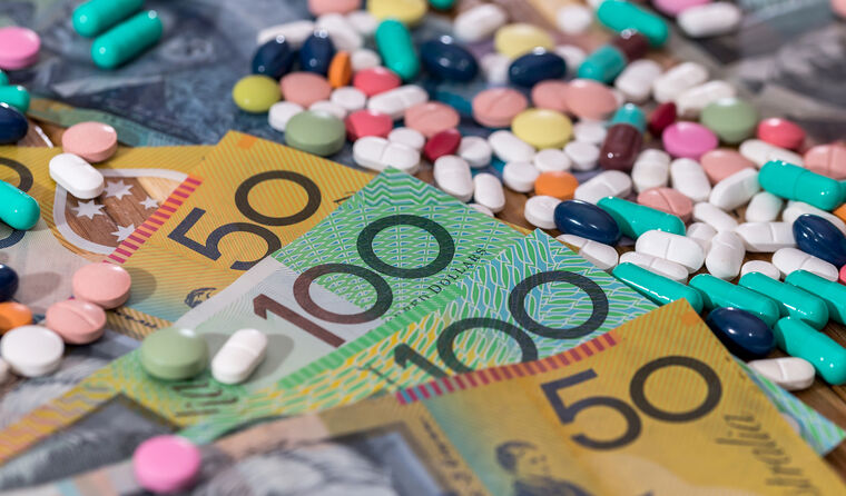  Colourful pills with Australian dollars on table