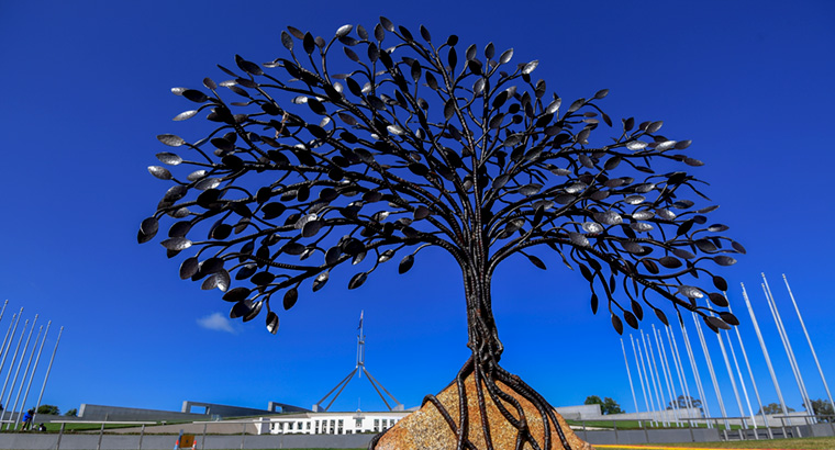 A memorial tree sculpture erected outside Parliament House ahead of Prime Minister Morrison’s apology to victims and survivors of institutional child sexual abuse. (Image: Lukas Coch)
