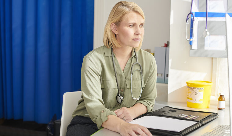 GP reviewing work on computer