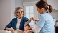 GP taking blood pressure test.