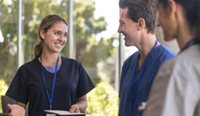 A group of trainee doctors talking.