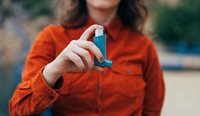 Young woman with asthma inhaler