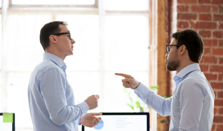 Two men arguing in an office.