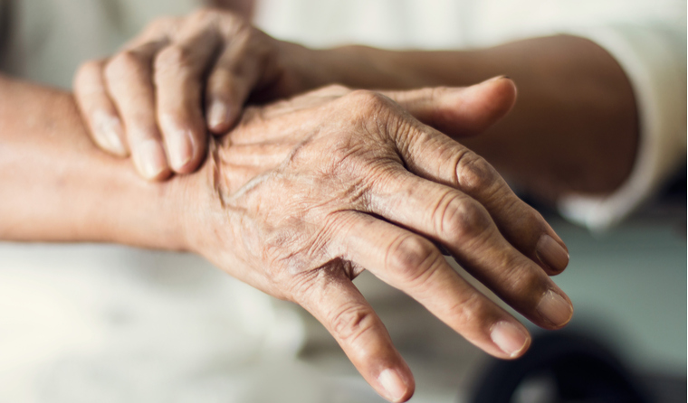 Close up hands of an elderly woman in pain.